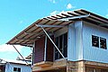 Hardwood purlins fixed to steel supports on a skillion roof and main roof. House under construction, tropical North Australia.