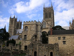 A stone tower rising above a group of stone buildings