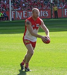 Barry Hall, Sydney player, kicking a football