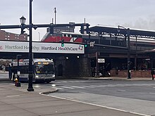 A CT Transit bus and CT Rail train by Hartford Union Station