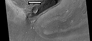 Wide view of a cliff and remains of a glacier, as seen by HiRISE under HiWish program