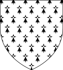 A shield shape. Inside the shield is a white background with black ermine symbols.