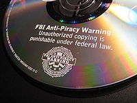 A DVD embossed with the FBI Anti-Piracy Warning, incorporating a modified FBI seal