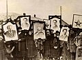 Image 21Russian peasants holding banners of Lenin (left), Marx (centre) and Trotsky (right) in early Soviet Russia. (from Russian Revolution)