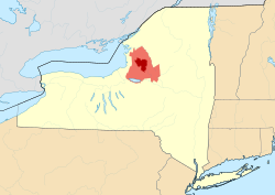 Map of New York State showing the greater Tug Hill region (light red), and its heavily forested "core" region (dark red). Core area based upon The Nature Conservancy's 150,000-acre (610 km2) delineation.[1]