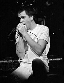 Black and white photograph of Gabriel singing in concert