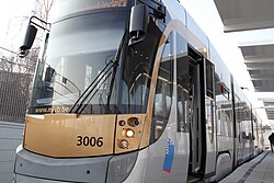 A grey tram with a logo on the side