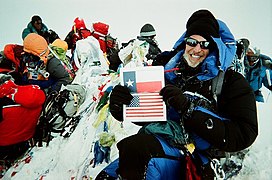 At Mount Everest summit with Texas Flag, 2010