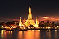 Image 46Wat Arun, the most prominent temple of the Thonburi period, derives its name from the Hindu god Aruṇa. Its main prang was constructed later in the Rattanakosin period. (from History of Thailand)
