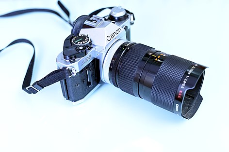 Canon camera with a 35~70 f/2.8~3.5 zoom lens. The advantage of a zoom lens is the flexibility, but the disadvantage is the optical quality. Prime lenses have a greater image quality in comparison.