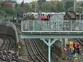 A row of London Underground D78 stock trains in old painted livery at Acton Depot viewed from Gunnersbury lane