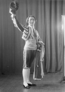 Portrait of Italian baritone Apollo Granforte standing with arm raised