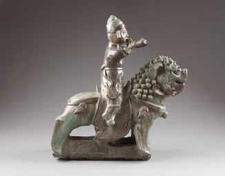 A horn blower riding a guardian lion, Qing dynasty