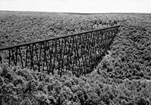 A black and white aerial photo of the Kinzua Bridge crossing the valley