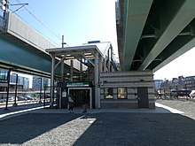 A ground-level entrance to an elevated railway station