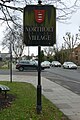 Village sign with Middlesex coat of arms