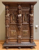 Henry II style wardrobe; c. 1580; walnut and oak, partially gilded and painted; height: 2.06 m, width: 1.50 m, depth: 0.60 m[99]