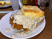 Biscuit with fried chicken thigh and sausage gravy at Biscuit Love in Nashville, Tennessee