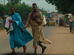 Men cross a busy street in Kayes, 2006.