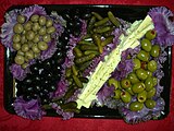 Olives and pickles attractively served on purple cabbage leaves