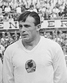 A footballer wearing a white jersey