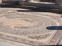 A close-up view of the floor mosaic containing a circle-within-a-square design