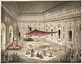 Funeral of Asaf-ud-Daulah in the year 1797 under a canopy inside the Bara Imambara; (note:Flag (green) of the Mughal Empire raised higher than the Awadh flag)