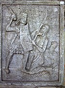 XX: Legionary with manica laminata and body defences of 'pteruges' and a corselet of scale, armed with sword, and a Dacian falxman; A Germanic warrior (Bastarnae?) sporting a Suebian knot lies injured on the ground