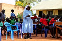 A Ugandan nun teaching during a community service day