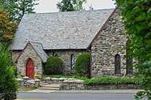 Stone English Gothic–style church with red door