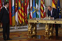 Juan Carlos signing his own abdication law in front of PM Rajoy, June 2014