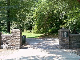 A park entrance, flanked by stone posts