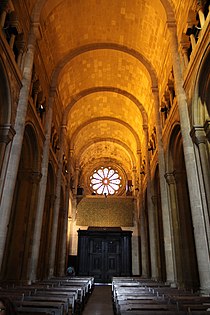 The nave of Lisbon Cathedral is covered by a series of transverse barrel vaults separated by transverse arches and has an upper, arched gallery (triforium).