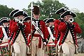 The United States Army Old Guard Fife and Drum Corps thrill an audience with their musical skills while on parade in 2008. The unit recalls the American Revolutionary era by dressing in colonial uniform and tricorn hats.