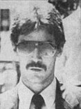 Black and white portrait of Michael Nitz wearing a suit and sunglasses