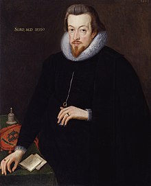 A portrait of Robert Cecil, who is standing at a table wearing black robes. He has neck-length brown hair and a pointed goatee. He has gold lettering behind him, which reads "sero, sed serio".