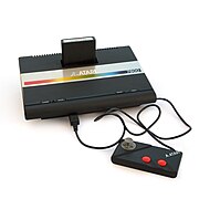 Atari 7800 games console with a single controller sitting at a slight angle