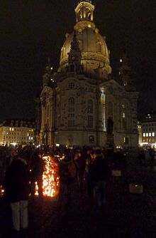 Church at night, with many people and candles