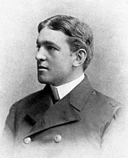 A black-and-white photo of Shackleton in three-quarters profile