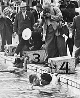 After Jean Boiteux won the 400 m freestyle race his father jumped into the pool to congratulate him
