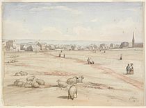 A watercolour showing the church in the distance with several buildings. Sheep are grazing in the foreground.