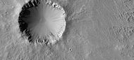 Crater showing layers and small craters in the ejecta that show a thin ejecta pattern Image taken with HiRISE under HiWish program.