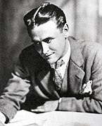 A photograph of writer F. Scott Fitzgerald sitting at a desk.