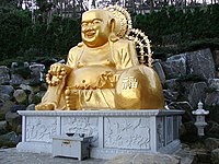 Statue of Budai as Maitreya at Haedong Yonggungsa temple in South Korea.