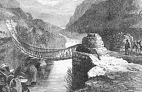 Rope bridge spanning a deep river valley.