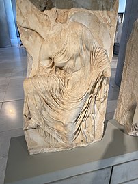 Nike adjusting her sandal, once part of the parapet beside the Temple of Athena Nike, c. 410 BC.