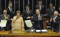 Dilma reads the oath of office, with President of the Chamber of Deputies Henrique Eduardo Alves at her right, and President of the Senate Renan Calheiros and Vice President Michel Temer.