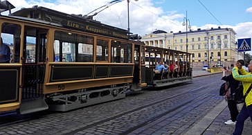 Trams travel on the eastern and southern sides of the square, and in this photograph special older models are being used