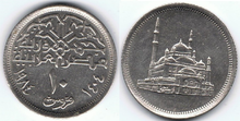 10 Egyptian piastres (copper-nickel alloy composition and silver color); coin’s obverse depicts Muhammad Ali Mosque from a flat perspective, coin reverse contains a Kufic font inscription of “Jumhuriyat Masr Al-Arabia”, translating to the Arab Republic of Egypt, below which the denomination of 10 piastres is written as number hovering over the word “qurush”, translating to piastres, which bends with the curvature of the coins edge, which is surrounded by the Gregorian (1984) and Hijra (1404) dates.