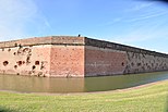 Wall that was breached and repaired with moat around the fort